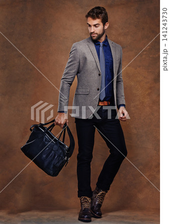 Confident, businessman and fashion with bag, proud on studio background. young man and leather handbag, style and trendy suit pose for consultant in startup, for professional career and corporate job 141243730