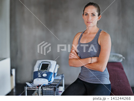 Portrait, woman and physio in studio for health with massage table for fitness, rehab and confidence. Female person, chiropractor and machine in clinic for wellness with muscles and electrotherapy Portrait, woman and physio in studio for health with massage table for fitness, rehab and confidence. Female person, chiropractor and machine in clinic for wellness with muscles and electrotherapy 141244268
