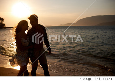Sunset, couple walk on beach and travel for anniversary or date with bonding, love and support. Calm, ocean peace and fresh air in nature, people outdoor and wellness, trust and care in relationship Sunset, couple walk on beach and travel for anniversary or date with bonding, love and support. Calm, ocean peace and fresh air in nature, people outdoor and wellness, trust and care in relationship 141244424