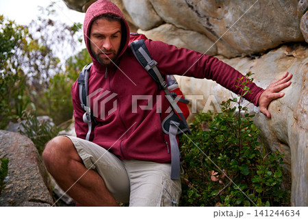 Cave, rock climbing and man hiking in mountain with backpack for adventure for wellness in trip. Earth, fitness and male person in environment to relax, peace and gear on hill or cliff and land Cave, rock climbing and man hiking in mountain with backpack for adventure for wellness in trip. Earth, fitness and male person in environment to relax, peace and gear on hill or cliff and land 141244634