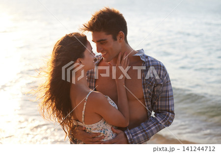 Sunshine, couple hug on beach and sea, travel for anniversary or date with bonding, love and support. Affection, peace and fresh air in nature, people outdoor with trust and care in relationship Sunshine, couple hug on beach and sea, travel for anniversary or date with bonding, love and support. Affection, peace and fresh air in nature, people outdoor with trust and care in relationship 141244712