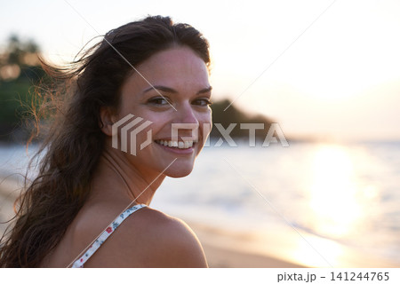 Woman, sunset and beach with portrait, smile and happy for wellness, travel and journey on island. Female person, cheerful and nature for vacation, holiday and outdoor in coastal, tropical and summer Woman, sunset and beach with portrait, smile and happy for wellness, travel and journey on island. Female person, cheerful and nature for vacation, holiday and outdoor in coastal, tropical and summer 141244765