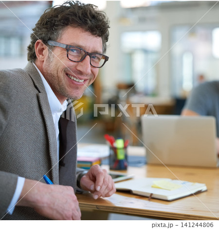 Happy, portrait and creative man in office with notebook for planning project with on desk. Mature, employee and productivity in coworking collaboration, cooperation or writing ideas in schedule 141244806