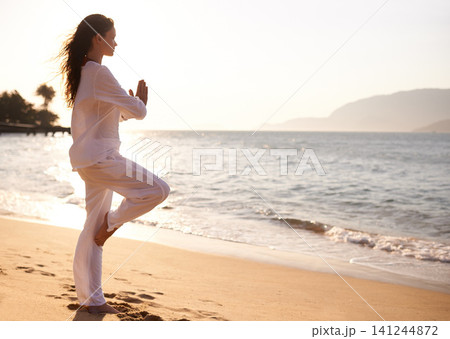 Beach, sunset or woman with prayer hands mediation in nature for peace, zen or mental health wellness. Spiritual, balance or female person at ocean for energy, breathing or holistic self care at sea 141244872