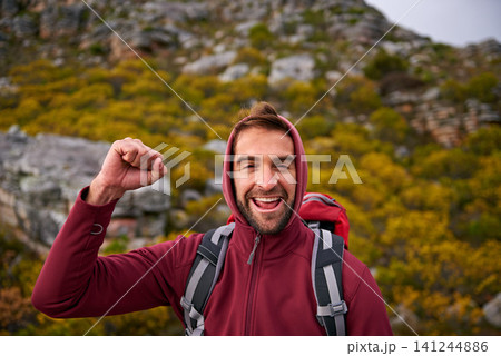 Portrait, celebration and man hiking in mountain, nature and victory with fist, wellness and health. Travel, trekking and male person with smile, happiness and adventure of guy with backpack in trip Portrait, celebration and man hiking in mountain, nature and victory with fist, wellness and health. Travel, trekking and male person with smile, happiness and adventure of guy with backpack in trip 141244886