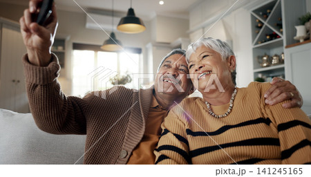 Senior couple, selfie and smile on sofa, hug and bonding with love, support and relax in retirement in home. Elderly woman, old man and happy with profile profile, web blog and social media on couch Senior couple, selfie and smile on sofa, hug and bonding with love, support and relax in retirement in home. Elderly woman, old man and happy with profile profile, web blog and social media on couch 141245165
