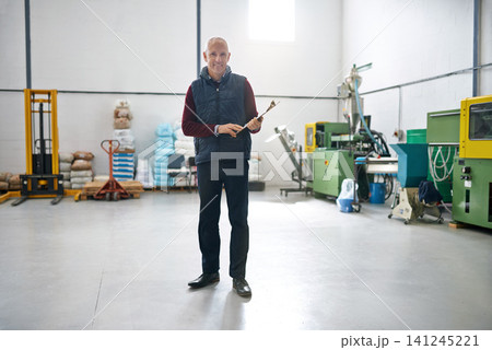 Man, manager and clipboard in warehouse with confidence in portrait, forklift and machinery in business. Male person, boss and checklist on factory floor with project management for quality assurance 141245221