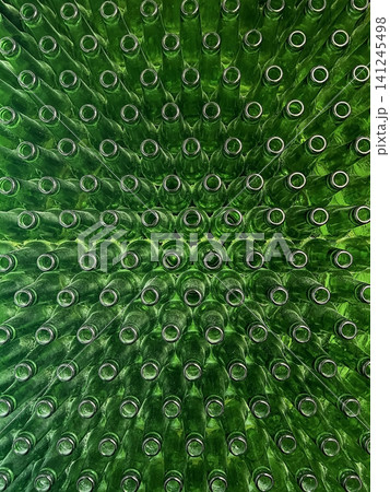 Abstract background of green glass bottles. Concept of glass recycling, reusable bottles, circular economy, bottle deposit return system (Pfand) and sustainable waste management. Abstract background of green glass bottles. Concept of glass recycling, reusable bottles, circular economy, bottle deposit return system (Pfand) and sustainable waste management. 141245498