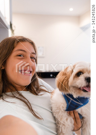 Playful teenage girl taking selfie with her small dog at home UGC Playful teenage girl taking selfie with her small dog at home UGC 141245826