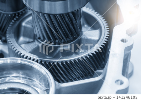 Macro shot of high-precision transmission gear parts in a blue tone scene with a lighting effect. Macro shot of high-precision transmission gear parts in a blue tone scene with a lighting effect. 141246105
