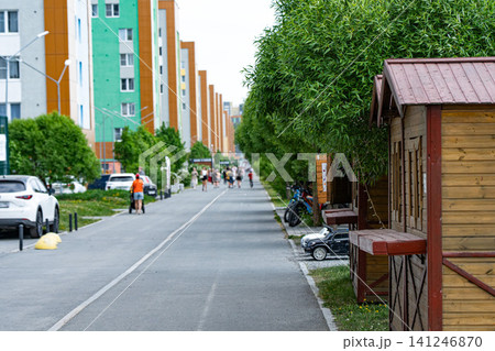 A Scenic Pathway with Lush Trees and Modern Buildings, Perfect for Leisurely Walks and Community Activities in a Vibrant Urban Environment A Scenic Pathway with Lush Trees and Modern Buildings, Perfect for Leisurely Walks and Community Activities in a Vibrant Urban Environment 141246870