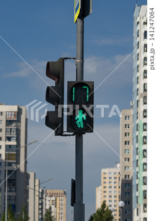Green Pedestrian Signal Illuminating City Streets, Indicating Safe Passage and Providing a Clear Signal for Walkers Amidst Urban Architecture Green Pedestrian Signal Illuminating City Streets, Indicating Safe Passage and Providing a Clear Signal for Walkers Amidst Urban Architecture 141247064