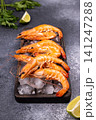 Fresh cooked shrimp on ice with lime and parsley 141247288