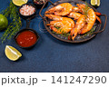 Cooked shrimp with sauce, lime, and herbs 141247290