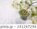 Dill scented bath salts with fresh herb on white surface 141247294