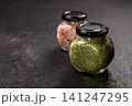 Pink himalayan salt and herbal salt in jars 141247295