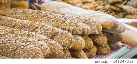 Freshly wholegrain baguette with grains on stall or in grocery shop 141247312