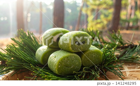 Fresh Korean Songpyeon Rice Cakes on Pine Needles with Forest Su Fresh Korean Songpyeon Rice Cakes on Pine Needles with Forest Su 141248295