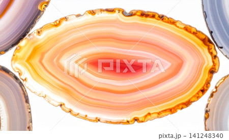 Close-up of translucent agate slices with vibrant orange and red 141248340