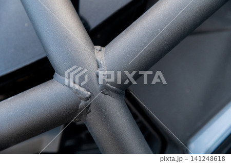 Close-up of welded metal tubing intersection in industrial setting 141248618