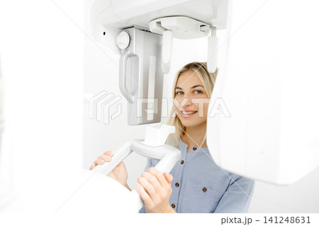 Young woman undergoing a dental panoramic radiography exam Young woman undergoing a dental panoramic radiography exam 141248631
