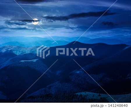 mysterious mountain landscape in summer at night. travel ukraine background. full moon over rolling hill in dappled light. scenic view of borzhava ridge. carpathian mountain scenery mysterious mountain landscape in summer at night. travel ukraine background. full moon over rolling hill in dappled light. scenic view of borzhava ridge. carpathian mountain scenery 141248640