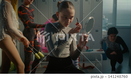 Teenage Gymnast Applying Stage Makeup Before Rhythmic Gymnastics Competition Teenage Gymnast Applying Stage Makeup Before Rhythmic Gymnastics Competition 141248760