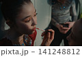 Teenage Rhythmic Gymnast Applies Lipstick to Teammate Using Soft Applicator 141248812