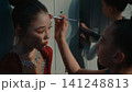 Young Gymnast Contours Teammate Face With Shimmering Shadows Before Rhythmic Gymnastics Competition 141248813