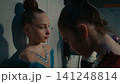 Teenage Gymnast Helping Her Friend Applying Stage Makeup Backstage 141248814