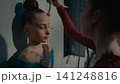Teenage Gymnast Helping Her Friend Applying Stage Makeup Backstage 141248816