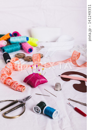 Sewing accessories for sewing and needlework on the table vertical view 141249351