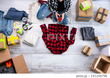 Girl Takes Photos Of Used Shirt For Online Selling, The Concept Of A Second Life For Things 141249796