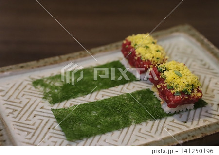 Garnished Beef Sushi on Decorative Plate 141250196