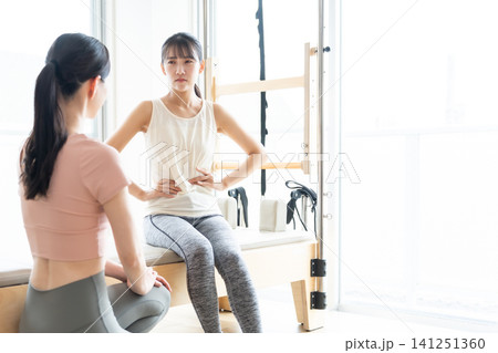 ピラティスの勧誘を受ける困った表情の女性 ピラティスの勧誘を受ける困った表情の女性 141251360
