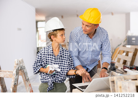 Father with son planning renovating of home Father with son planning renovating of home 141252218