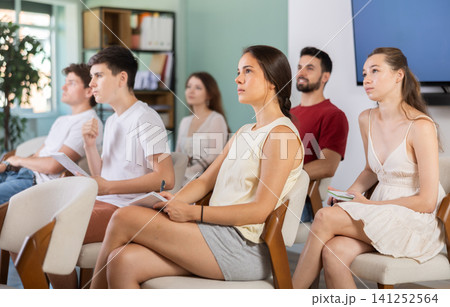 At meeting room during lecture, visitors listen to teacher At meeting room during lecture, visitors listen to teacher 141252564