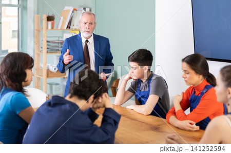 During round table conference, senior man mentor shouts at worker students During round table conference, senior man mentor shouts at worker students 141252594
