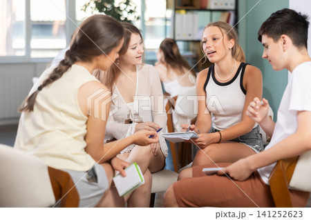 Students have divided into two teams and are discussing tactics of debate or competition Students have divided into two teams and are discussing tactics of debate or competition 141252623