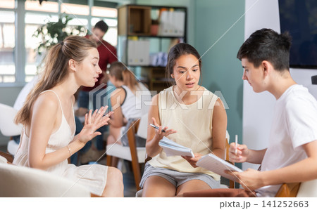 Students have divided into two teams and discussing tactics of debate under teacher guidance Students have divided into two teams and discussing tactics of debate under teacher guidance 141252663