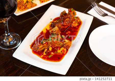 Asian style sticky ribs in sweet and spicy sauce 141252711