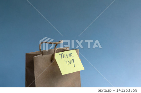 Thank you note attach to a brown gift bag Thank you note attach to a brown gift bag 141253559