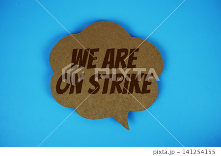 We Are On Strike text with speech bubble on blue background We Are On Strike text with speech bubble on blue background 141254155