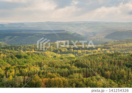 Layers of green mountains and hills in the haze during sunset. Panoramic View of Green hills and Meadow. Layers of green mountains and hills in the haze during sunset. Panoramic View of Green hills and Meadow. 141254326