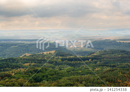 Layers of green mountains and hills in the haze during sunset. Panoramic View of Green hills and Meadow. Layers of green mountains and hills in the haze during sunset. Panoramic View of Green hills and Meadow. 141254338
