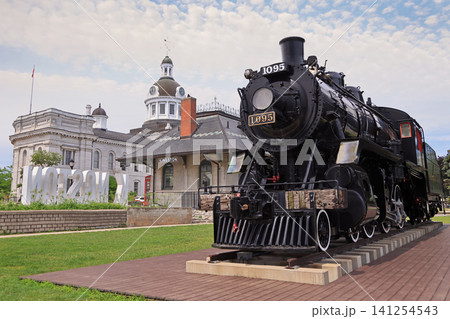Kingston City Hall with the restored Historic black steam locomotive 1095 displayed on tracks on the foreground, Canada 141254543