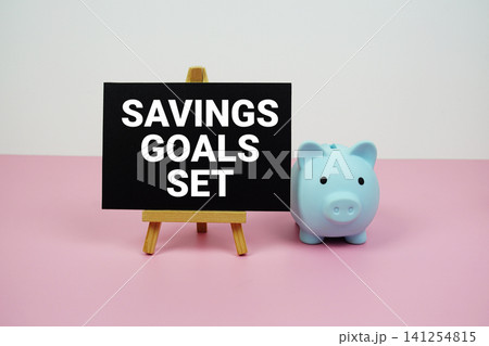 Savings Goals Set text written on paper card with easel and piggy bank Savings Goals Set text written on paper card with easel and piggy bank 141254815