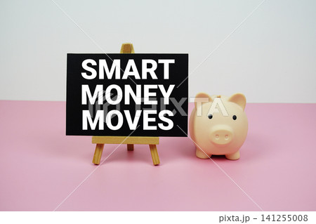 Smart Money Moves text written on paper card with easel and piggy bank Smart Money Moves text written on paper card with easel and piggy bank 141255008