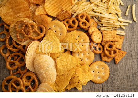 Mix of variety snack chips pretzel and cracker, junk crunchy food. Mix of variety snack chips pretzel and cracker, junk crunchy food. 141255111