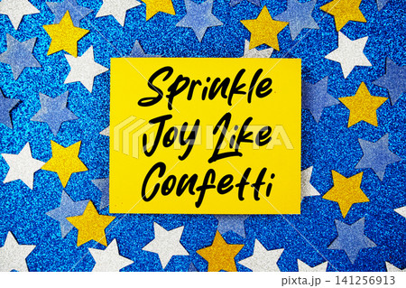 Sprinkle Joy Like Confetti text written on paper card with star glitter on blue background Sprinkle Joy Like Confetti text written on paper card with star glitter on blue background 141256913